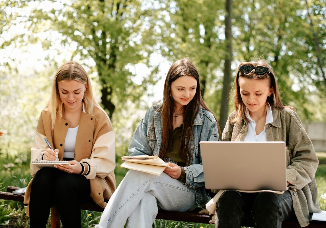 three_students_studying_outdoors